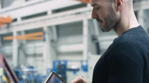 Engineer using an app in a factory Stock Footage 132703749
