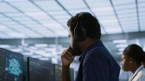 Engineer using audio device to hear podcasts in data center 스톡 사진