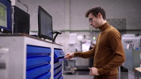 Engineer using computer to change the inventory Stock Footage 260510336