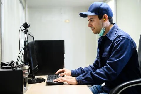 Engineer using a desktop pc in a factory for automation processes 写真素材