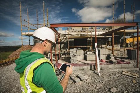 Engineer using digital tablet at the construction site 写真素材