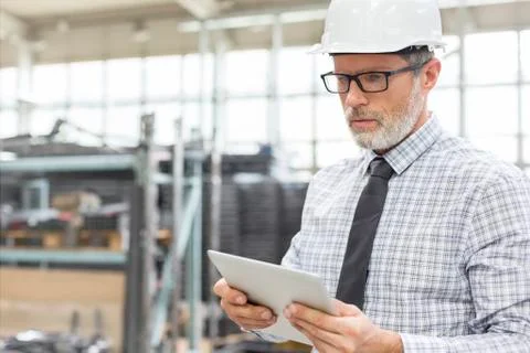 Engineer using digital tablet in factory Stock Photos