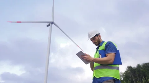 Engineer Using Digital Tablet in Wind Turbine Farm. Stock-Footage 212482051