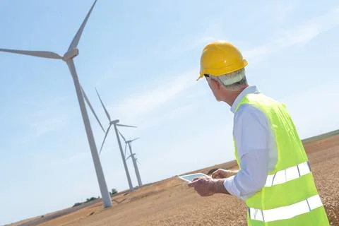 Engineer using digital tablet for wind turbine inspection Stock Photos