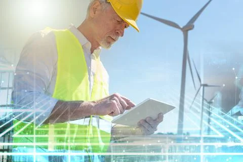 Engineer using digital tablet for wind turbine inspection; multiple exposure Stock Photos