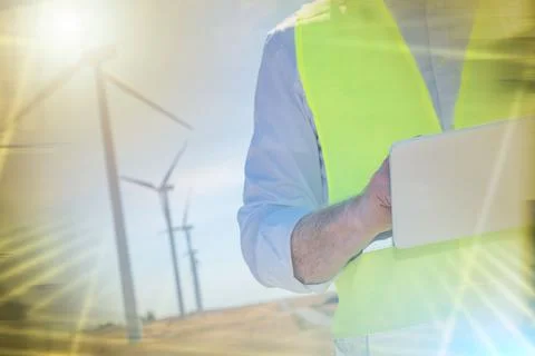 Engineer using digital tablet for wind turbine inspection; multiple exposure 写真素材