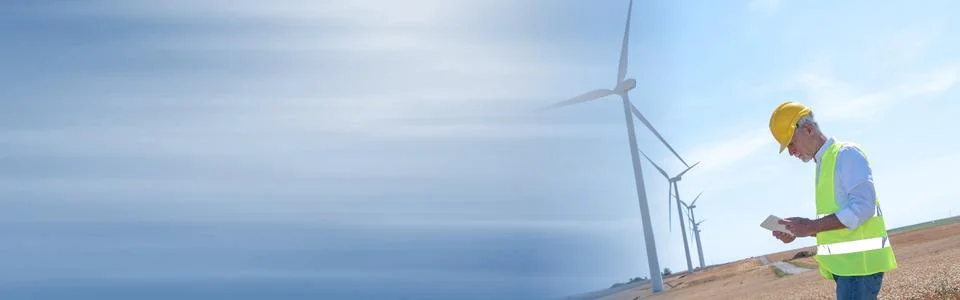 Engineer using digital tablet for wind turbine inspection; panoramic banner Stock Photos