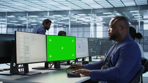 Engineer using green screen computer, working in server farm Stock Footage 319577027