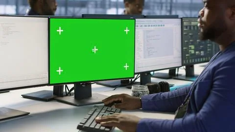 Engineer using green screen computer, working in server farm 스톡 사진