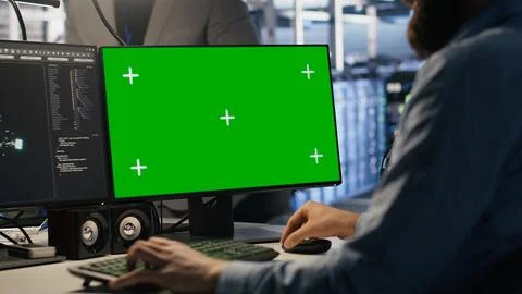 Engineer using green screen mockup PC in data center to update servers Stock Photos