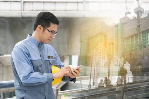 Engineer using his smartphone Stock Photos