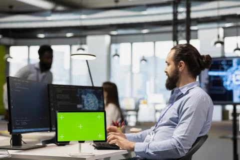 Engineer using isolated screen tablet to adjust machine learning algorithms 写真素材