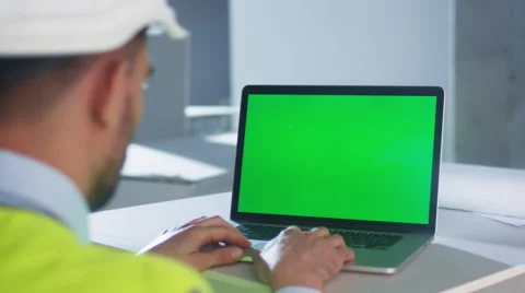 Engineer using Laptop Computer with Green Screen on Construction Stock Footage 67543808