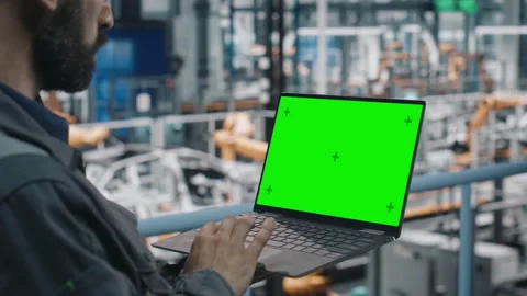 Engineer Using Laptop Computer Green Screen at Car Factory Stock Footage 158941305