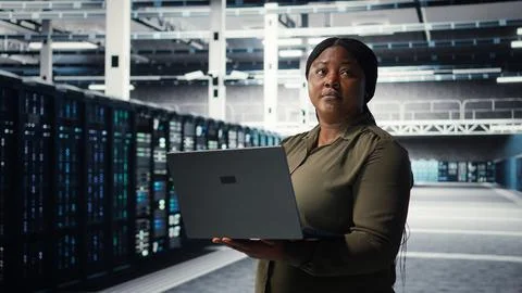 Engineer using laptop in data center, integrating new technologies Stock Photos