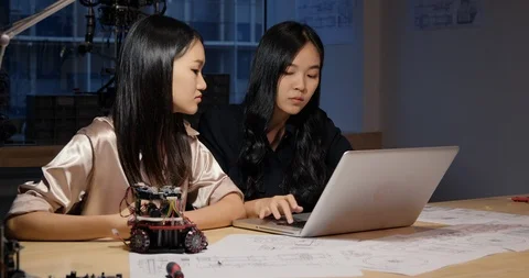 Engineer using laptop to research information to make robot. Stock Footage 111254384