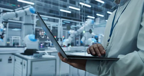 Engineer Using Laptop in Robotics Factory Video stock 319830180