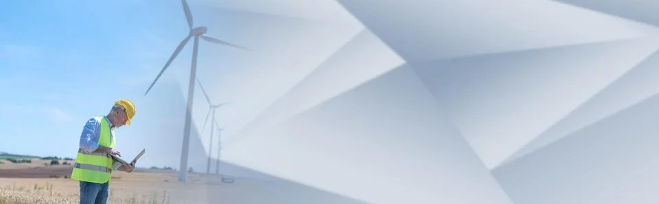 Engineer using laptop for wind turbine inspection; panoramic banner Stock Photos