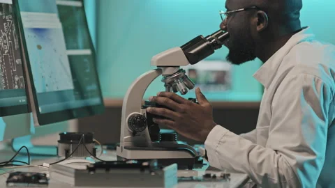 Engineer Using Microscope for Examining Electronics in Lab Video stock 170117784