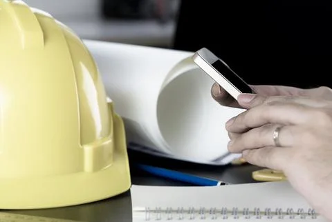 Engineer is using mobile phone in office Stock Photos