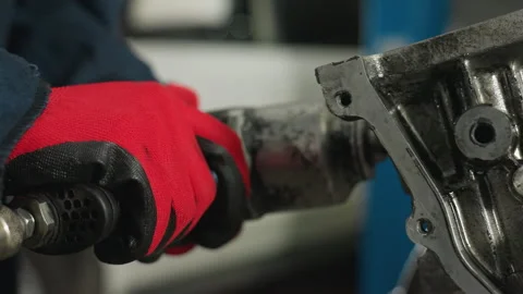 Engineer Using Pneumatic Tool on Engine Block in Industrial Workshop Stock Footage 301252276