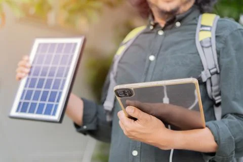 Engineer using portable solar panel for charge his tablet pc for working ou.. Stock Photos