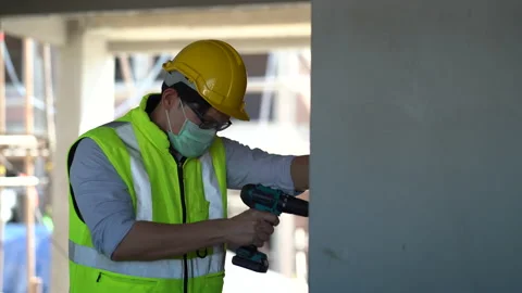 Engineer using power drill in construction site Stock Footage 146440520