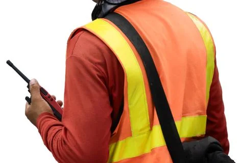 An engineer is using a radio communication device in an outdoor environment. 写真素材