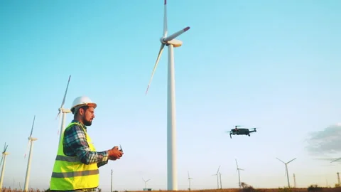 Engineer using a remote control for remote inspection of wind turbine Video stock 247845730