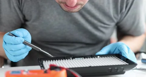 Engineer using screwdriver testing led lamp closeup Stock Footage 172056777