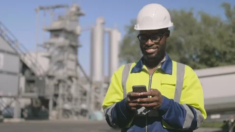 Engineer using smartphone outdoors 스톡 동영상 114331387