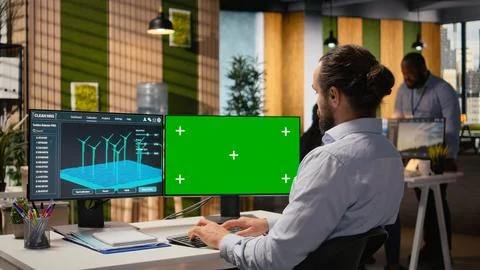Engineer using software on mockup PC used for planning wind farm layouts 스톡 사진