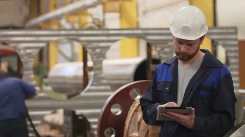 Engineer using tablet and and look around in modern heavy industry factory Stock-Footage 65404362