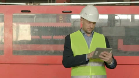 Engineer using tablet inside factory workshop Stock Footage 123285103