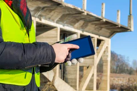 Engineer using tablet near the bridge in winter Stock Photos