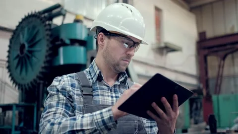 Engineer Is Using Tablet Pc In Factory. Slow-Motion. Stock Footage 171776046