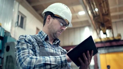 Engineer Is Using Tablet Pc In Factory. Slow-Motion. Stock Footage 171776124