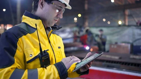 Engineer Is Using Tablet Pc In Factory. Slow-Motion. Stock Footage 240084314