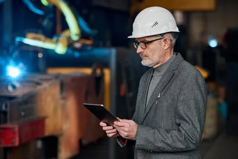 Engineer using tablet pc at his work Stock Photos