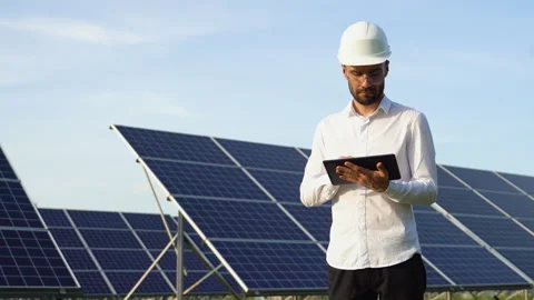 Engineer using tablet to test solar panels. High solar energy usage Stock Footage 245570502