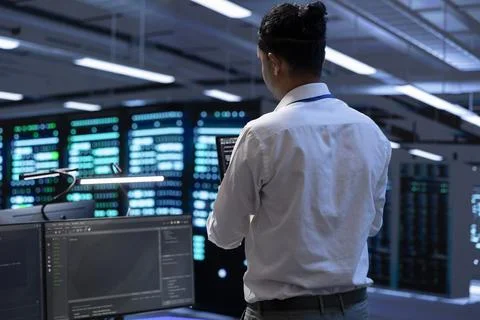 Engineer using tablet to troubleshoot hardware and software issues in server hub Stock Photos