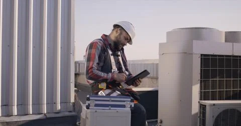 Engineer using a tablet while having a phone call Stock Photos