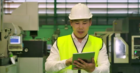 Engineer using tablet while walking through factory. Stock Footage 153454831
