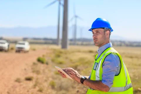 Engineer using tablet on a wind farm 스톡 사진