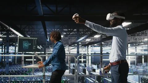 Engineer using VR headset in data center to update server tech Stock Photos