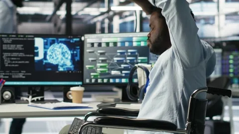 Engineer using wheelchair in data center using AI node tree software Stock Footage 309509499