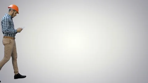 Engineer using a wireless tablet to check construction project on white Vídeo Stock 73643396