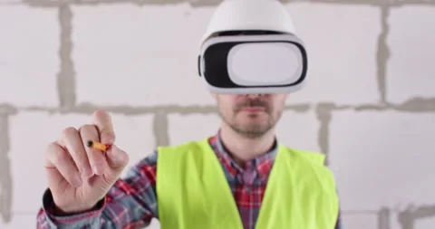 Engineer in virtual reality glasses draws objects with pencil Stock Footage 309930454