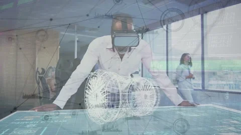Engineer in VR HMD leaning over touch table, activating rotating wireframe HUD Stock Footage 333965843