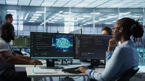 Engineer waiting at PC desk for checkup to be done on server room Stock Footage 319250206